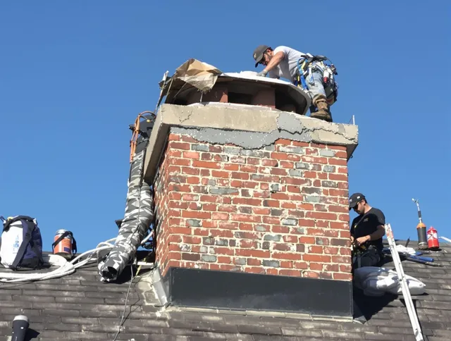 Bedford Chimney Sweep installing a custom chimney crown in Bedford, MA