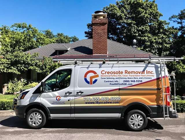 Bedford Chimney Sweep technician removing creosote safely in Bedford, MA