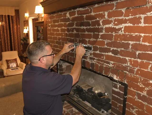 Bedford Chimney Sweep expert fixing a fireplace in Bedford, MA